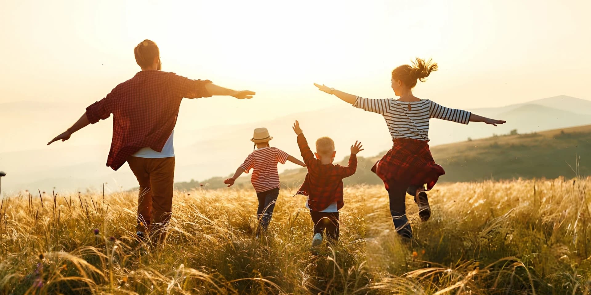 Intended parents celebrating outdoors with their children  after finding a private surrogate
